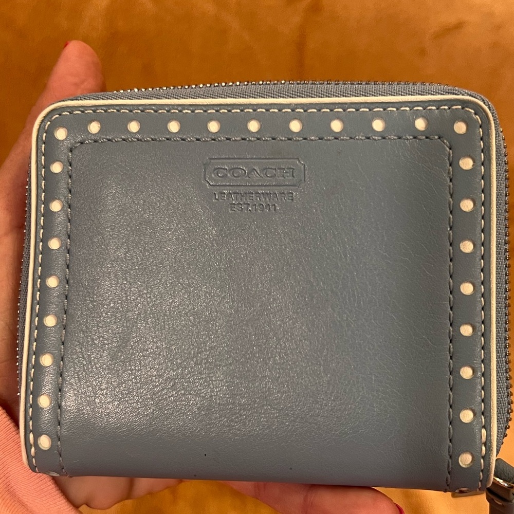 Small coach zip around wallet. This is a baby blue with white circles etching.